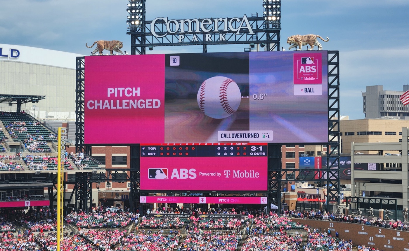 Comerica Park scoreboard revealing the ruling on a challenged pitch — a measurement showing the ball 0.6 inches from the strike zone, with the call marked overturned