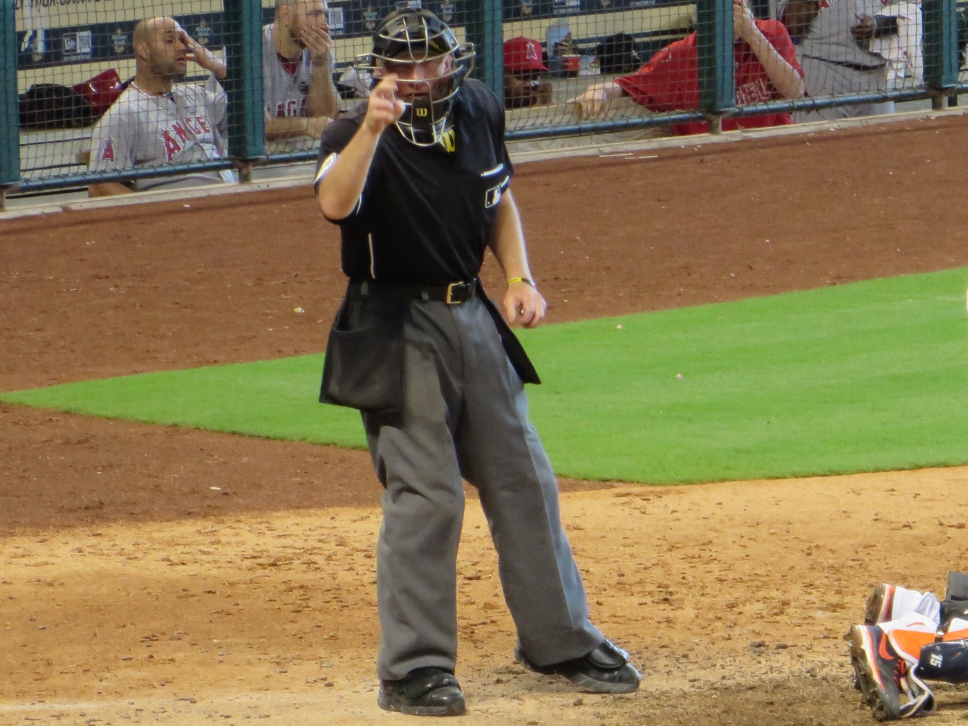 A Major League home-plate umpire pointing and calling a strike