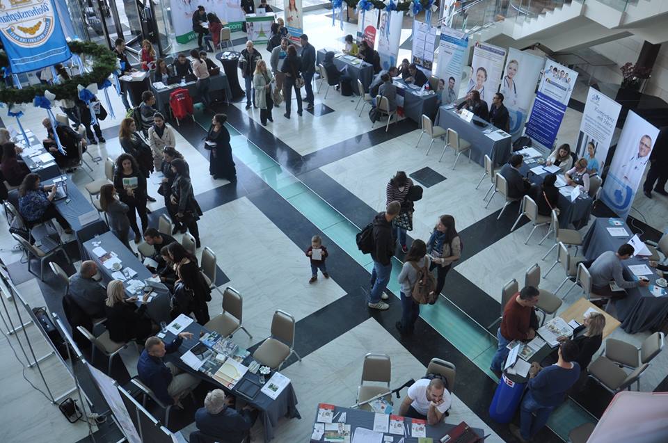 Job seekers browse employer booths at a 2015 job fair in Sofia — entry-level hiring in AI-exposed roles has dropped 16% since generative AI spread, hitting young adults first