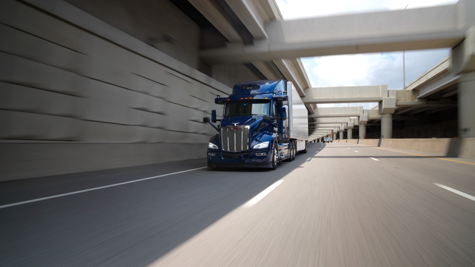 An Aurora self-driving truck running on an elevated highway in Texas
