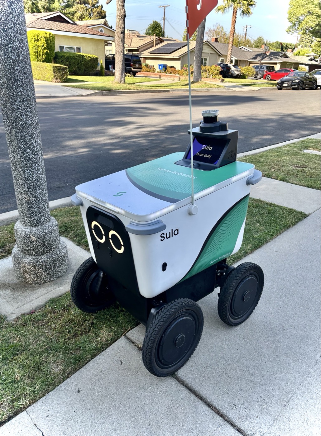 A Serve Robotics delivery robot with a cylindrical camera and sensor module mounted on top