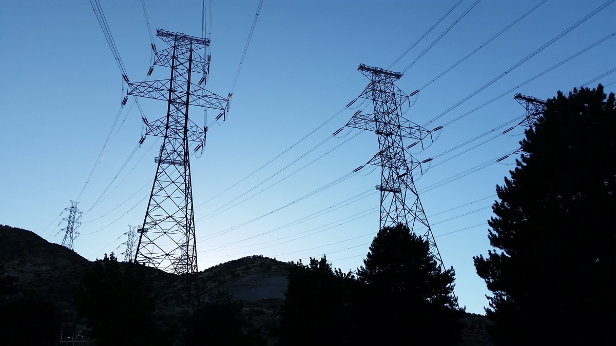 High-voltage transmission towers and power lines against the sky