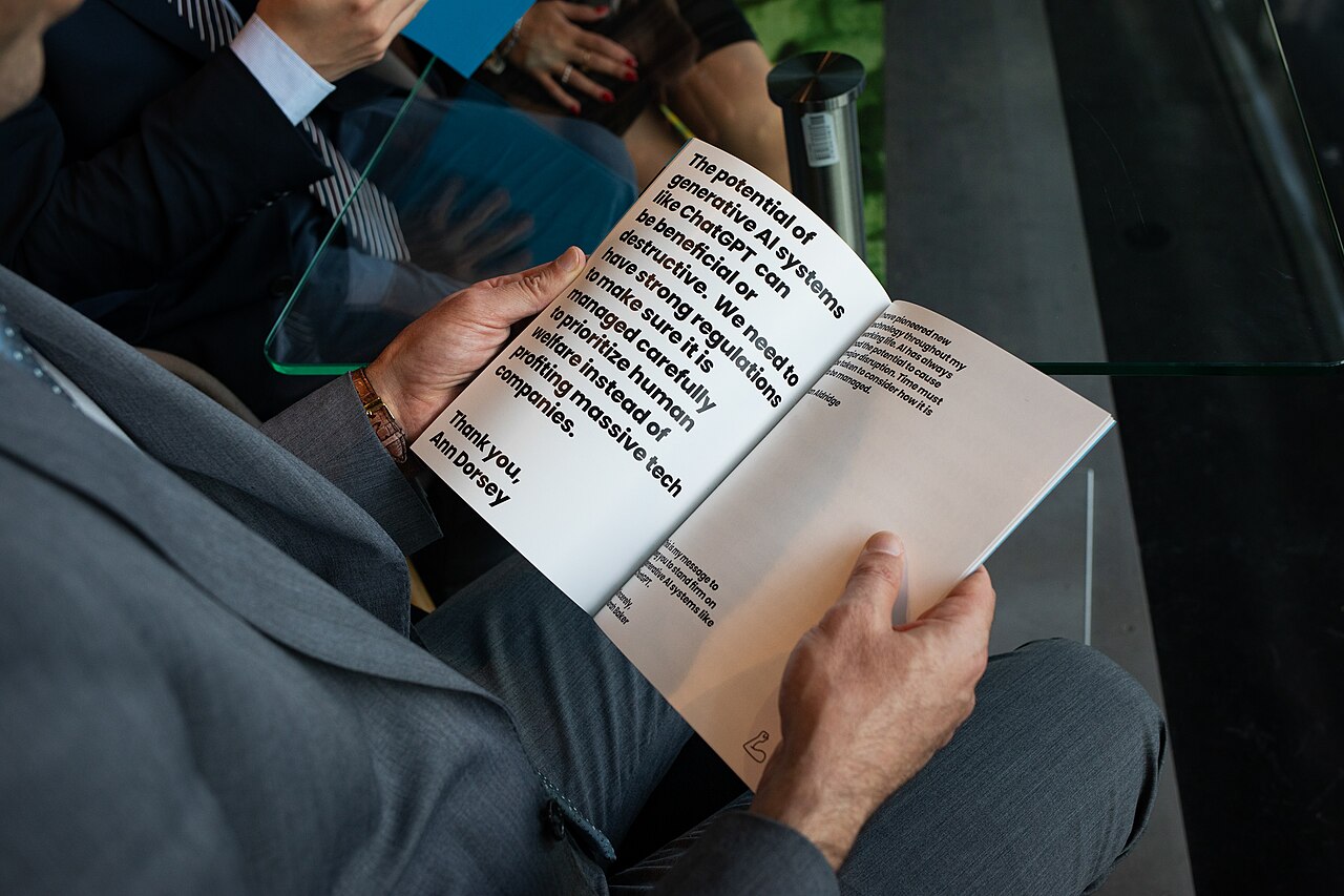 A delegate reading a citizen's message on AI regulation and human welfare at the EU Parliament in Strasbourg