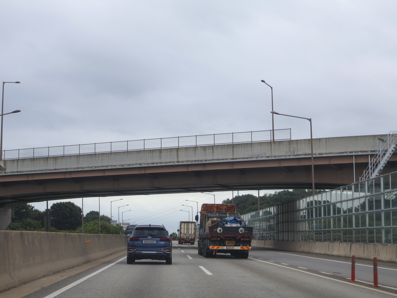 Traffic passing under a bridge on a Korean expressway — the type of site physical AI inspection robots are meant to enter