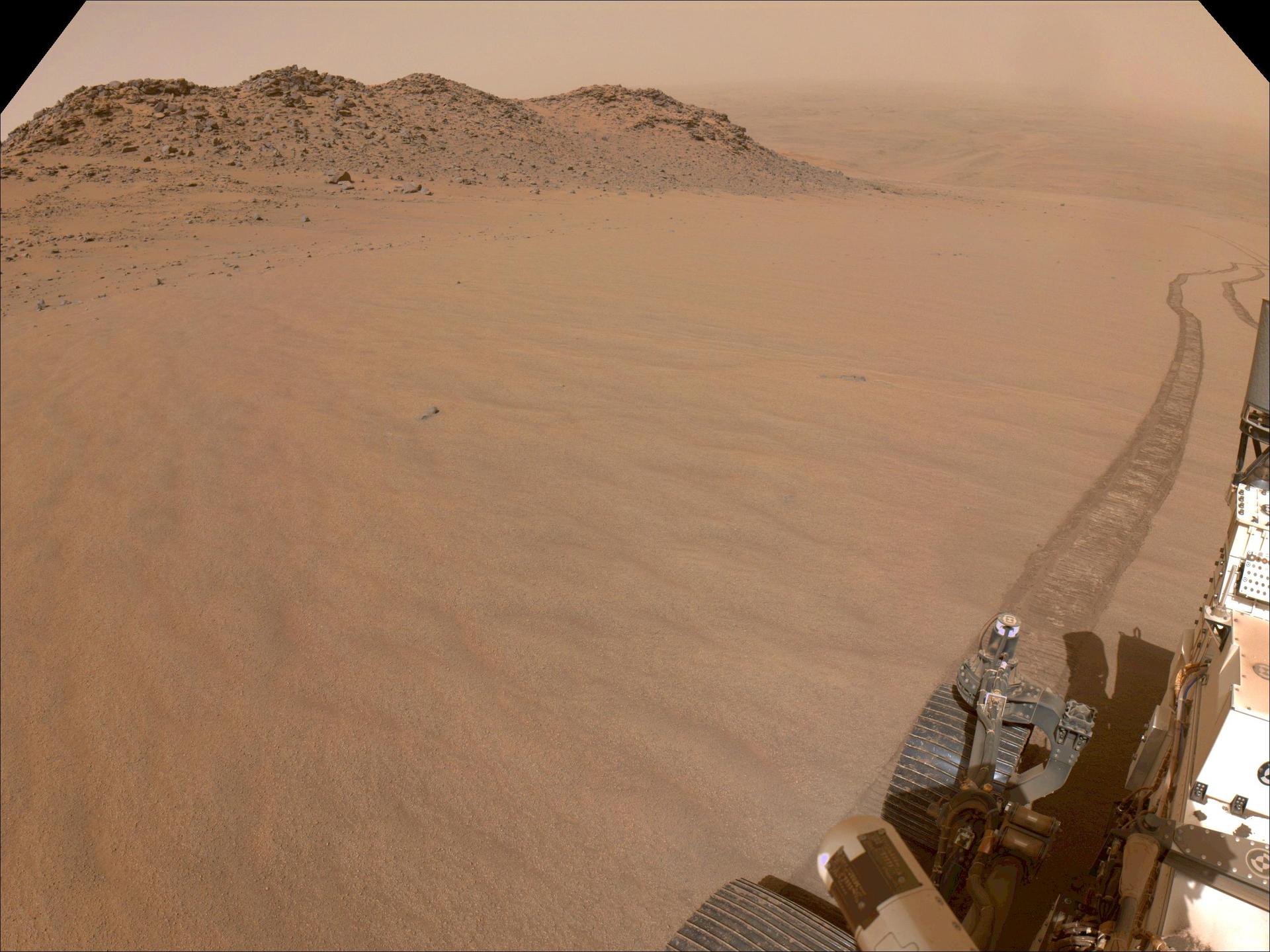 Wheel track left by Perseverance climbing a sandy Martian slope toward the crater rim, Sol 1326 navigation camera image