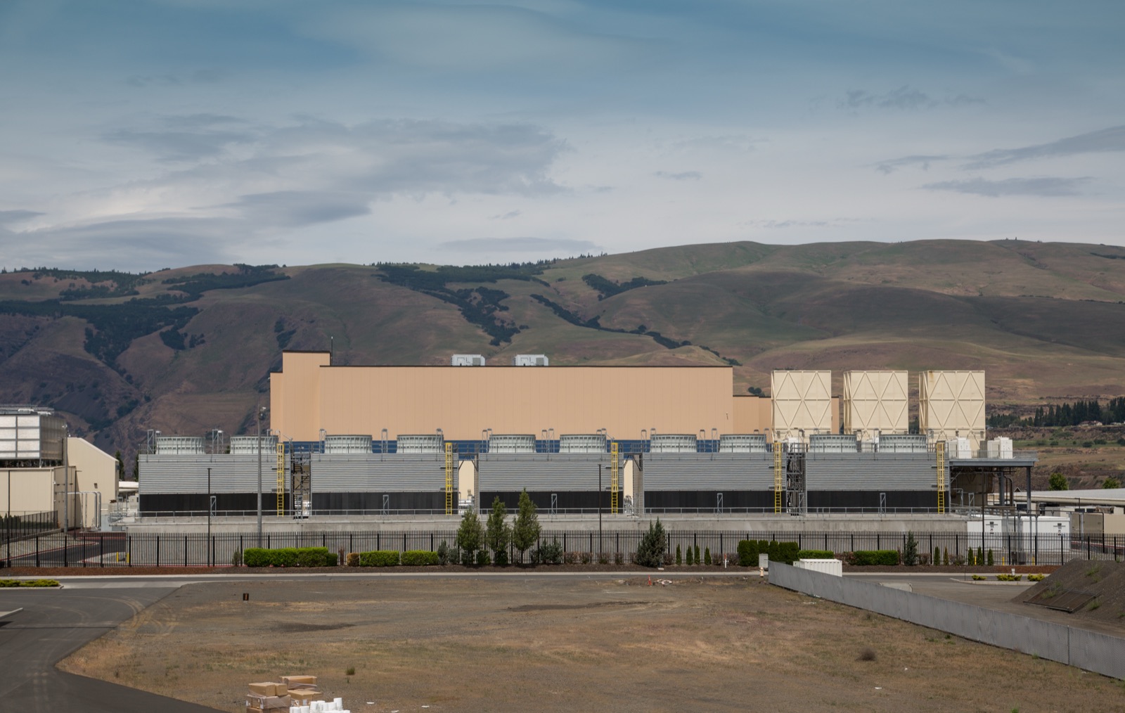 Exterior of a large-scale AI data center building with cooling infrastructure