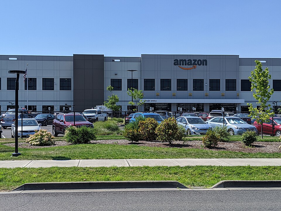 Amazon fulfillment center in Troutdale, Oregon — Bezos is applying the same flywheel strategy to physical AI, acquiring manufacturing and engineering firms to own operational data