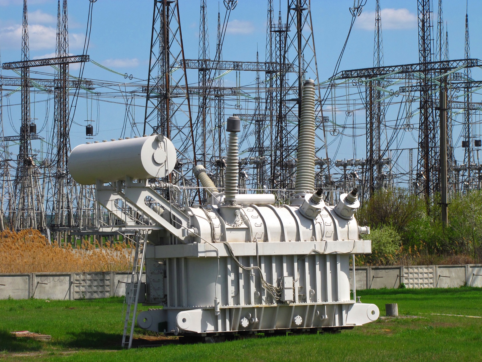 Large high-voltage power transformer installed inside a substation — equipment with an average 128-week delivery lead time