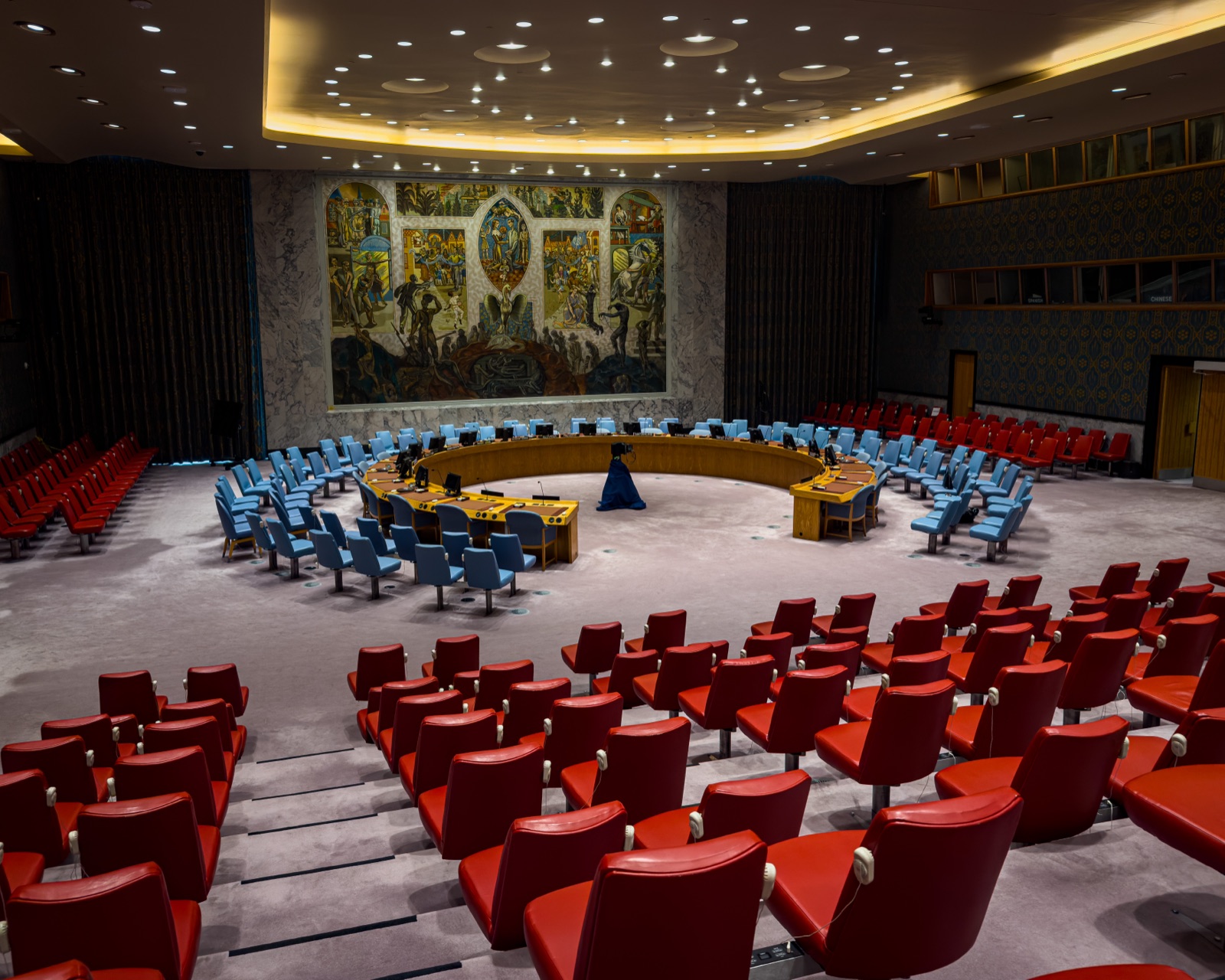 Interior of the UN Security Council chamber — the horseshoe table and briefer's seat