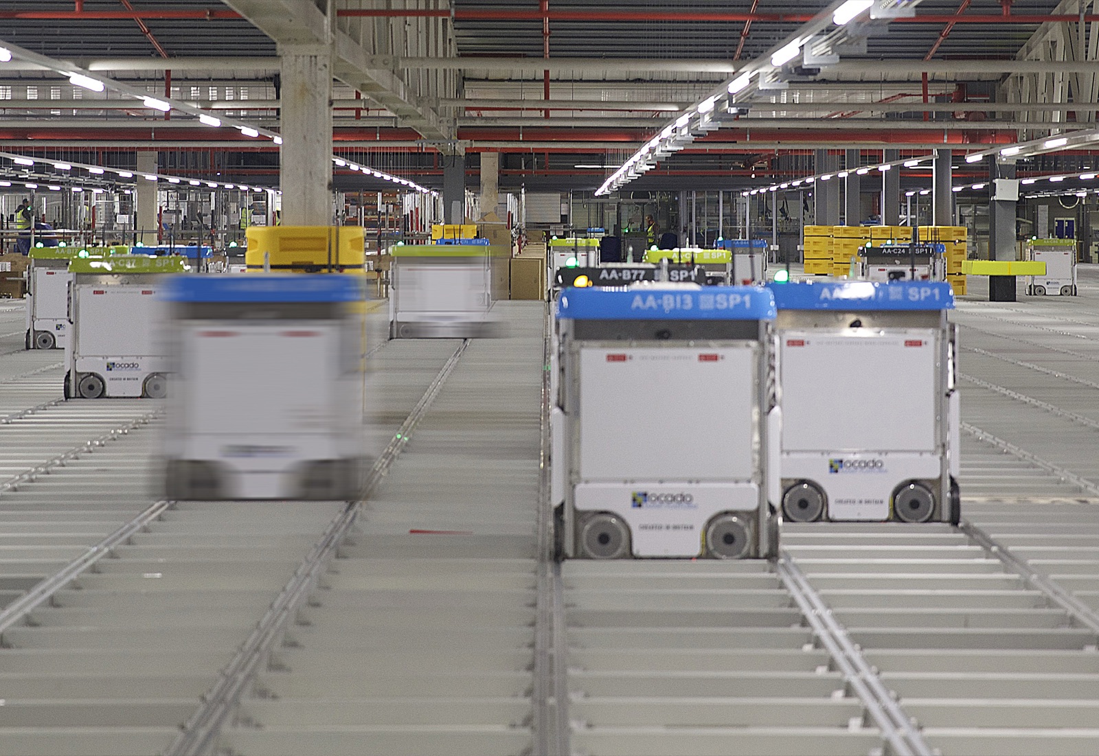 Autonomous mobile robots (AMR) moving along tracks in an automated warehouse — a live source of robot motion data