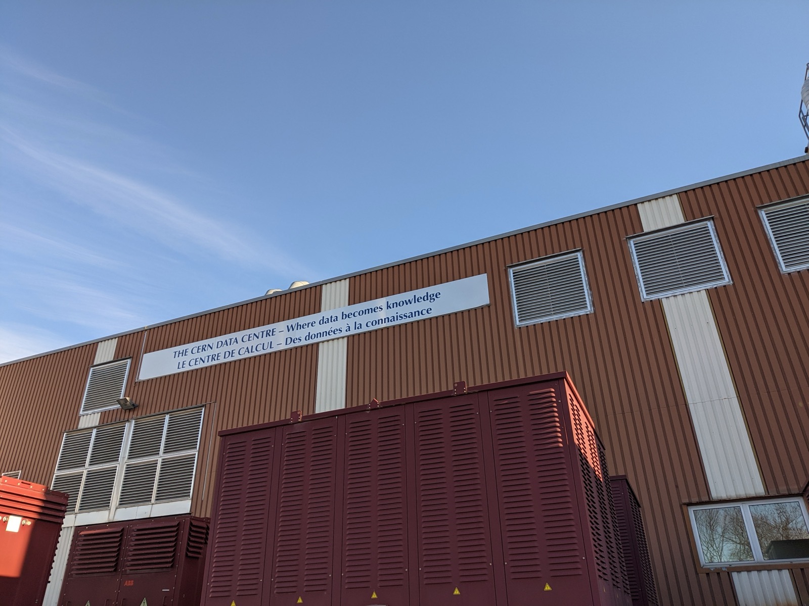Data center building exterior with cooling equipment — a typical hyperscale AI data center facade
