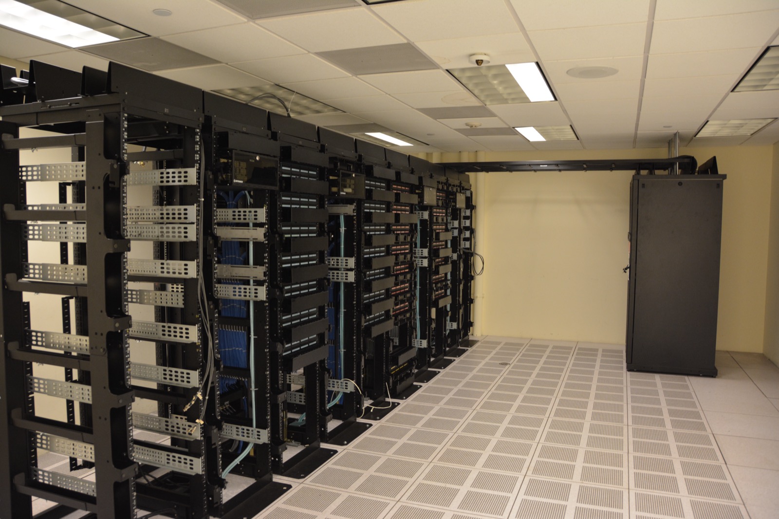 Server racks inside a data center — the real compute infrastructure that extracts useful output per watt