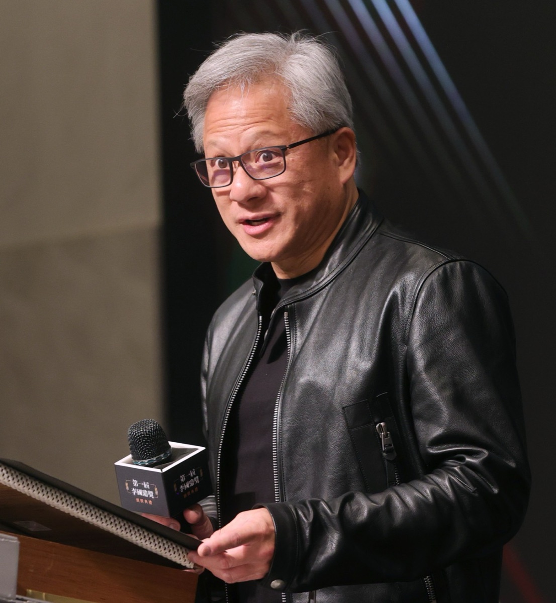 NVIDIA CEO Jensen Huang speaking at a podium