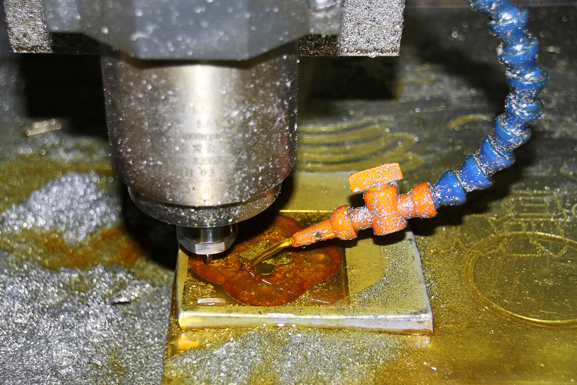 CNC milling machine in operation — close-up of cutting tool with coolant in precision machining